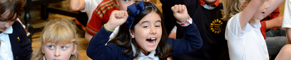 School children cheering with their hands in the air